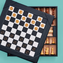 Load image into Gallery viewer, Luxury leather chessboard and checker set, shown with chess pieces on board. Navy leather, opened to see storage space for pieces. Set with checkers on board.
