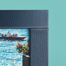 Load image into Gallery viewer, High-end leather picture frame with white contrast stitching. Holds 5x7" photo. Navy blue leather shown, close-up of corner shown.
