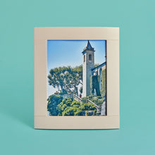 Load image into Gallery viewer, Cream luxury leather picture frame with white stitching detail, holds 8x10" photo, standing vertically
