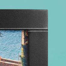 Load image into Gallery viewer, High-end leather picture frame with white contrast stitching. Holds 5x7" photo. Black leather shown, close up of corner shown.