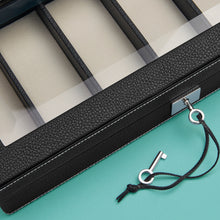 Load image into Gallery viewer, Expensive watch case, black leather with white stitching, close up shot to show glass top, leather and white stitching