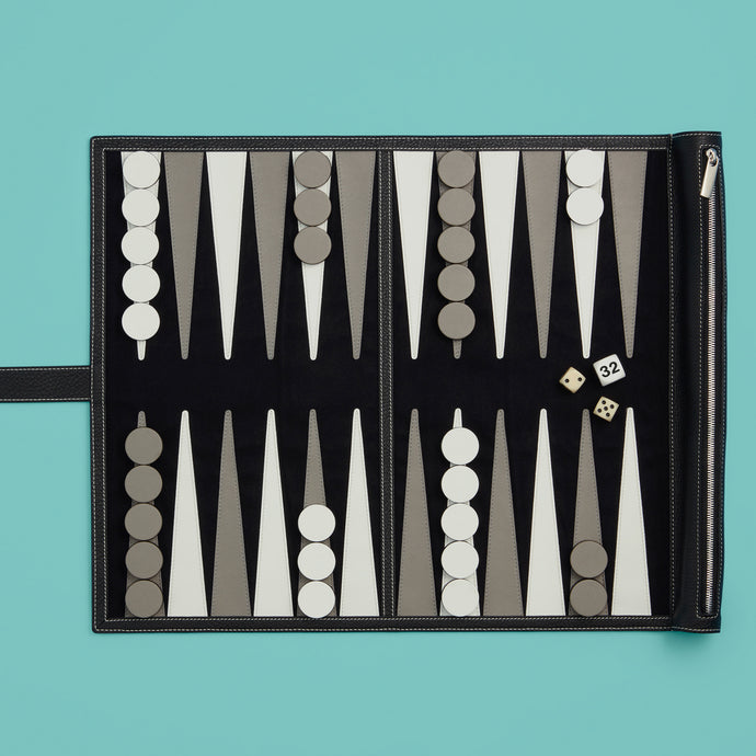 Luxury black leather travel backgammon set, shown unrolled, exposing leather backgammon board, with pieces and dice