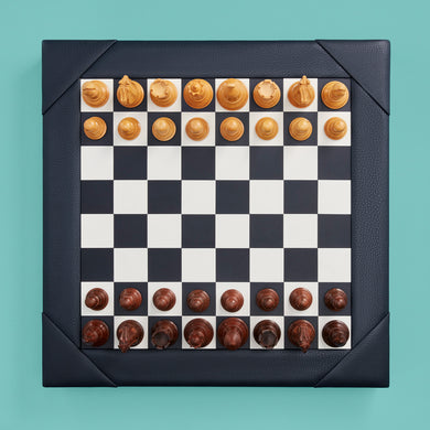 Luxury leather chessboard and checker set, shown with chess pieces on board. Navy high-end leather board, beautiful wood carved pieces.