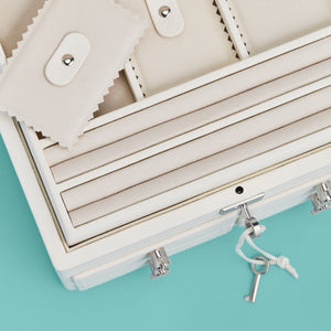 High-end leather jewelry box with 4 drawers. Cream white leather, detail shot of drawers and lock and key.