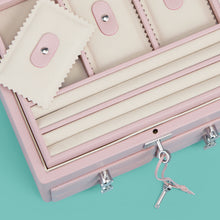 Load image into Gallery viewer, High-end leather jewelry box with 4 drawers. Light pink leather, detail shot of drawers and lock and key.
