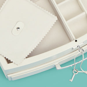 High-end leather jewelry box with drawer. Cream white leather, detail shot of drawers and lock and key.