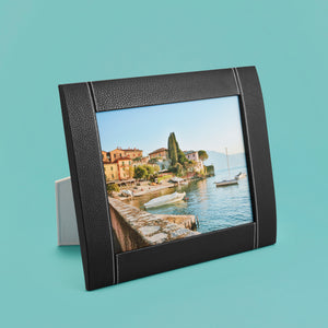 Black luxury leather picture frame with white stitching detail, holds 8x10" photo, standing horizontally