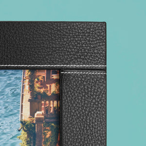 Close up of white stitching detail on black luxury leather photo frame