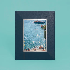 High-end leather picture frame with silver interior detail, holds 5x7 photo, navy blue leather, shown standing vertically