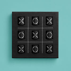Luxury leather tic tac toe board with white stitching. Shown in black leather, shown head-on.