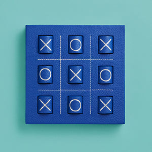 Luxury leather tic tac toe board with white stitching. Shown in blue leather. Shown head on.